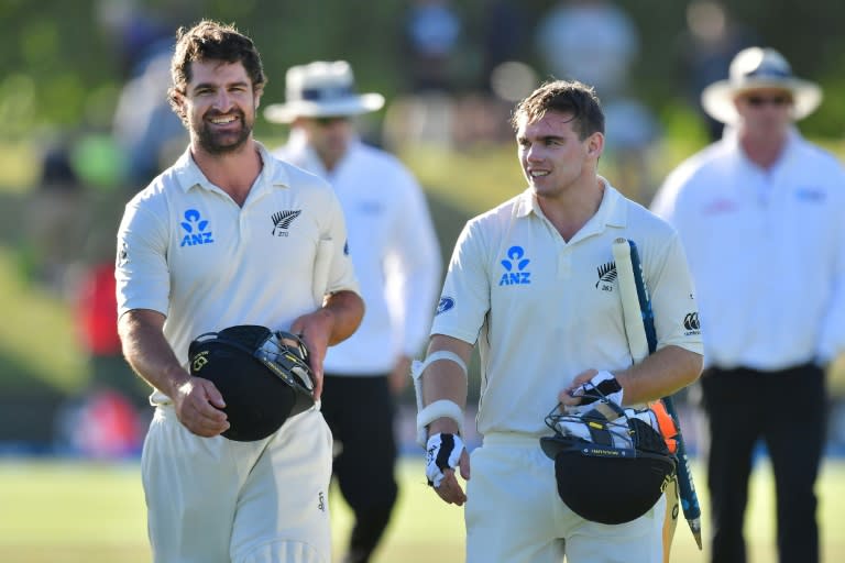 New Zealand's Colin De Grandhomme and Tom Latham (R) walk off the field after defeating Bangladesh in their second Test match, at Hagley Park Oval in Christchurch, on January 23, 2017