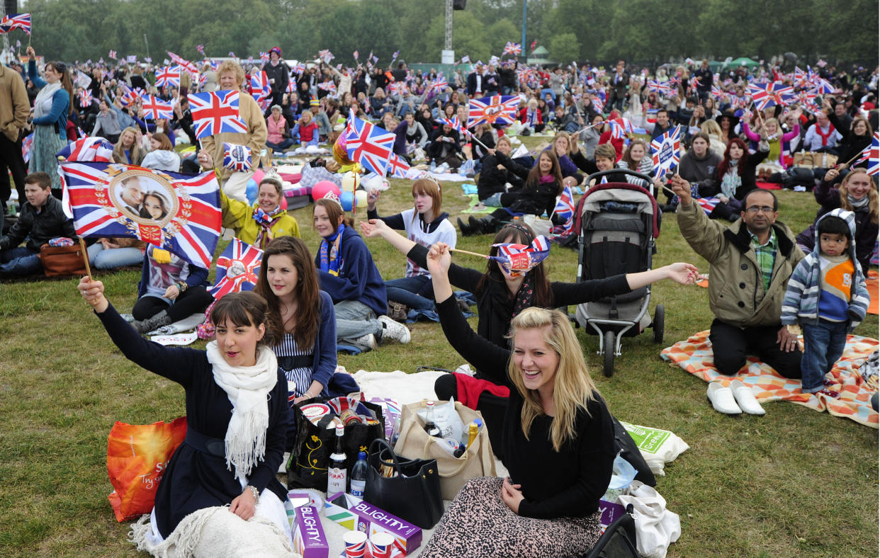 Royal supporters hold British Union Jack flags in Hyde Park in central London, on the day of the royal wedding of Britain's Prince William and Kate Middleton, on April 29, 2011. AFP PHOTO / CARL COURT (Photo credit should read CARL COURT/AFP via Getty Images)