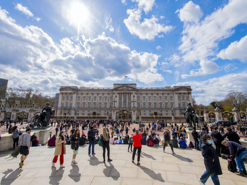 People gather outside Buckingham Palace, London, following the announcement of the death of the Duke of Edinburgh at the age of 99.