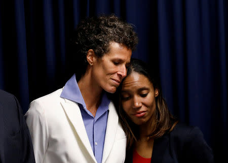 Bill Cosby accuser Andrea Constand embraces Special Prosecutor Kristen Gibbons Feden during a news conference after a jury convicted actor and comedian Bill Cosby for sexual assault during a retrial in Norristown, Pennsylvania, U.S., April 26, 2018. REUTERS/Brendan McDermid/Files