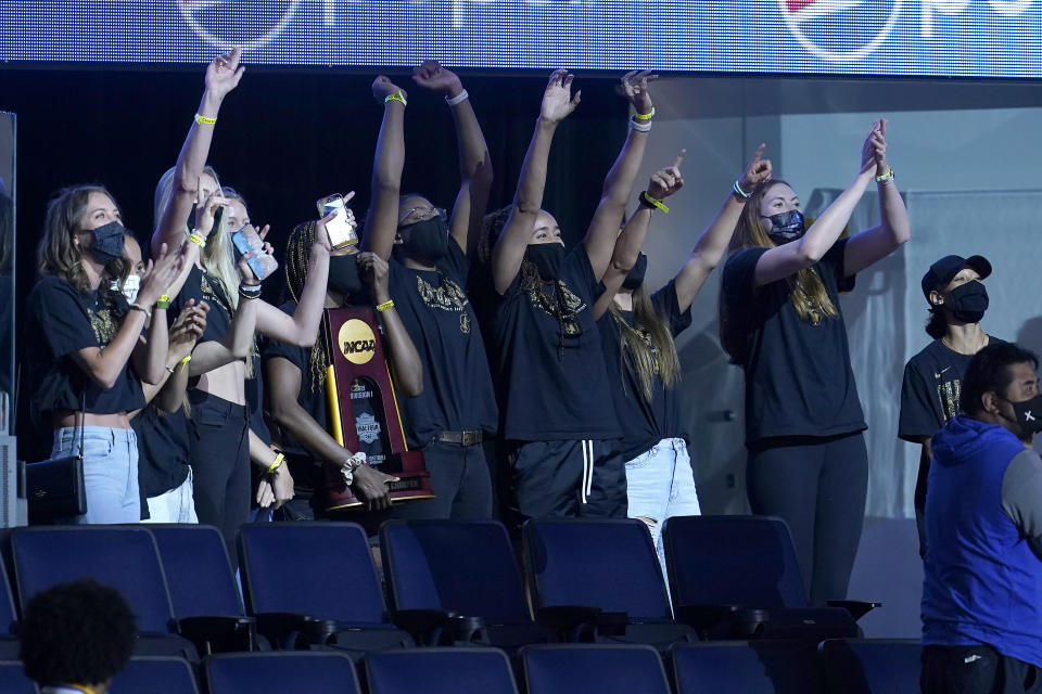 Players from the Stanford national championship women's basketball team wave while acknowledged during the first half of an NBA basketball game between the Golden State Warriors and the Utah Jazz in San Francisco, Monday, May 10, 2021. (AP Photo/Jeff Chiu)