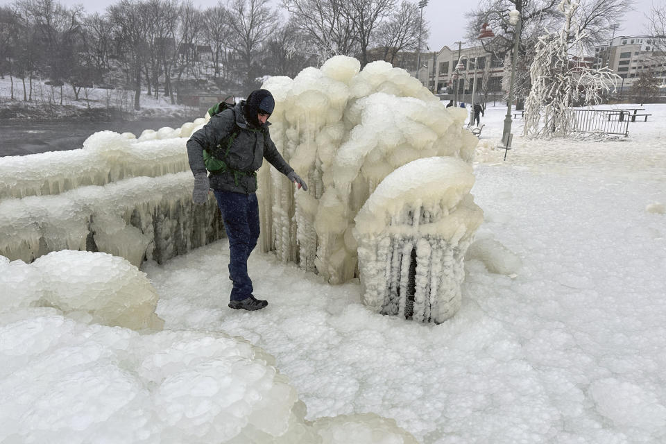 Mist from the Great Falls has created a frozen wonderland around the waterfalls in Paterson, N.J., on Thursday, Jan. 18, 2024. People are braving the subfreezing cold temps and slippery walkways to visit the ice-covered trees, benches and lamposts. (AP Photo/Ted Shaffrey)