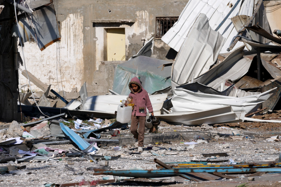 A Palestinian child walking in the rubble in Deir al Balah in the Gaza Strip following an Israeli attack (AP)