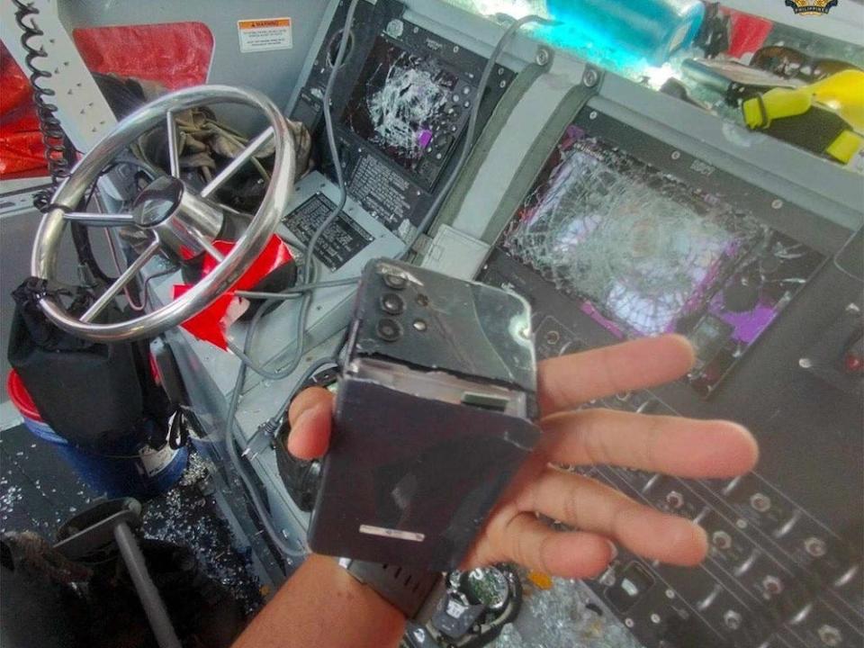 A handout image shared by the Armed Forces of the Philippines shows a hand holding broken equipment, in front of a smashed-up control panel on a Filipino boat, the result of a skirmish by the Chinese Coast Guard on June 17, 2024.