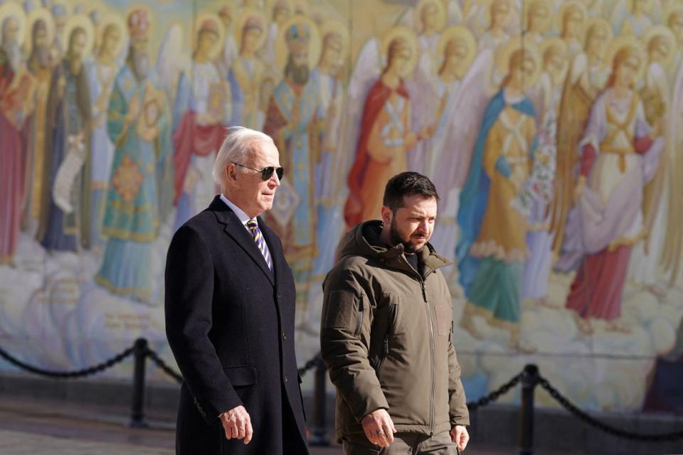 U.S. President Joe Biden (L) walks next to Ukrainian President Volodymyr Zelensky past a religious mural at the St. Michael's Golden-Domed Cathedral, as he arrives for a visit in Kyiv on Feb. 20, 2023. Biden made a surprise trip to Kyiv ahead of the first anniversary of Russia's full-scale invasion of Ukraine. (Dimitar Dilkoff/AFP via Getty Images)