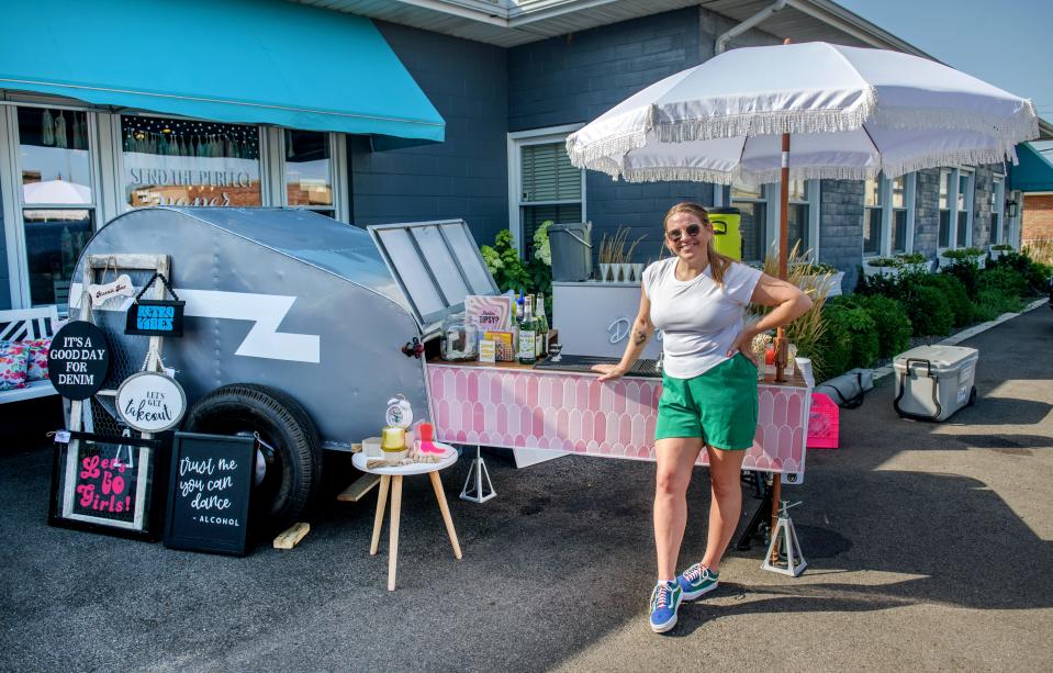 Megan Eilts stands with her business Happenstance Mobile Bar during an event at So Chic Boutique in Morton. Eilts converted a small vintage camper into the bar complete with a built-in ice box.