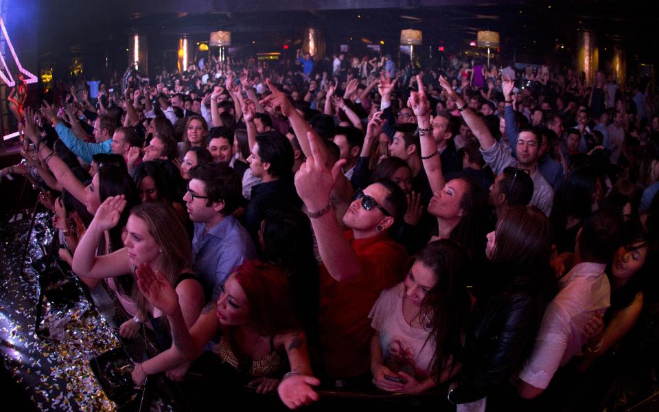 Revelers dance to the music played by DJ Afrojack inside the XS nightclub in Las Vegas on Sunday, Jan. 20, 2013. (AP Photo/Julie Jacobson)