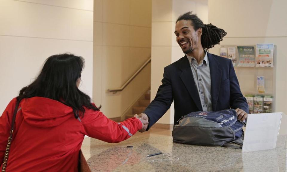 Braxton Winston, right, greets a Charlotte city staffer as he arrives for an orientation meeting at the government center last week.