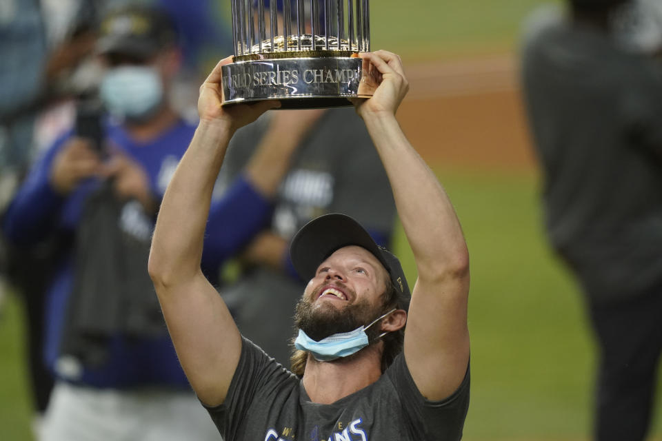 Los Angeles Dodgers pitcher Clayton Kershaw celebrates with the trophy after defeating the Tampa Bay Rays 3-1 to win the baseball World Series in Game 6 Tuesday, Oct. 27, 2020, in Arlington, Texas. (AP Photo/Eric Gay)