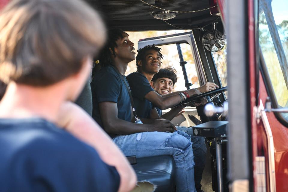 Students from the Fire Service Education Program check out a fire truck to be used as a learning tool at Fulton High School in Knoxville on Nov. 15, 2023. The city of Knoxville donated the fire truck, previously used in action, to the program for students to get hands-on, real-life experience.