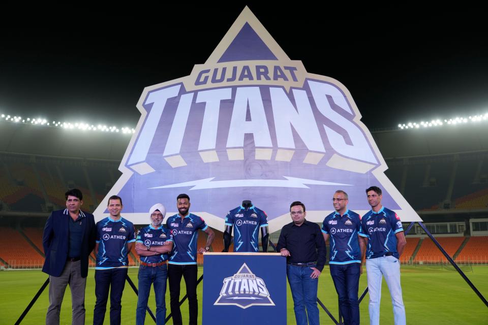 IPL team Gujarat Titans's COO Col. Arvinder Singh, left, Gujarat Titans's Director of Cricket Vikram Solanki, 2nd left, Captain Hardik Pandya, 4th left, BCCI secretary Jay Shah, 3rd right and Head Coach Ashish Nehra, right launch team jersey at Narendra Modi stadium in Ahmedabad, India, Sunday, March 13, 2022. (AP Photo/Ajit Solanki)