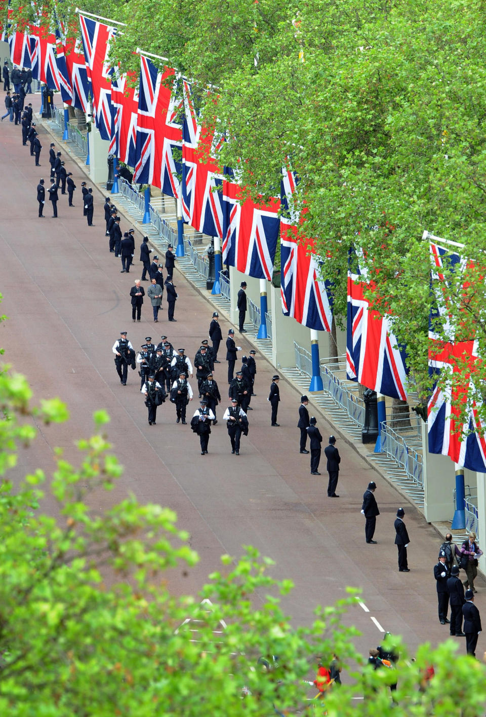 Police arrive in the Mall, London, before Queen Elizabeth II leaves Buckingham Palace, London, for a service of thanksgiving at St Paul's Cathedral as part of the Diamond Jubilee celebrations Tuesday June 5, 2012. Queen Elizabeth II will make a rare address to the nation at the conclusion of festivities marking her 60 years on the throne. (AP Photo/Anthony Devlin, Pool)