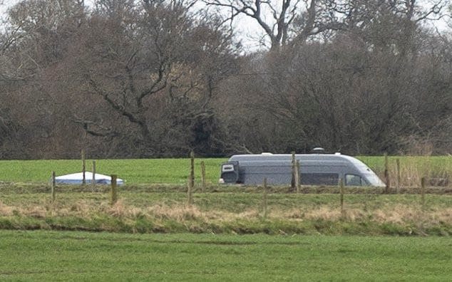 A white forensic tent is seen on the riverside - Ryan Jenkinson / Story Picture Agency