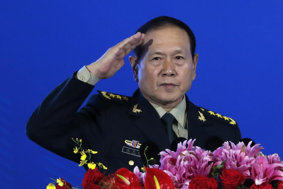 Chinese Defense Minister Wei Fenghe salutes after delivering his opening speech for the Xiangshan Forum, a gathering of the region's security officials, in Beijing, Monday, Oct. 21, 2019. Wei is issuing a stinging rebuke of the U.S. at a defense forum in Beijing, saying China wasn't fazed by sanctions, pressure and a "big stick policy." (AP Photo/Andy Wong)