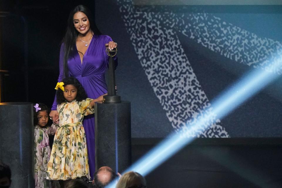 Vanessa Bryant on stage with daughters Capri and Bianka after speaking during Kobe Bryant's enshrinement.