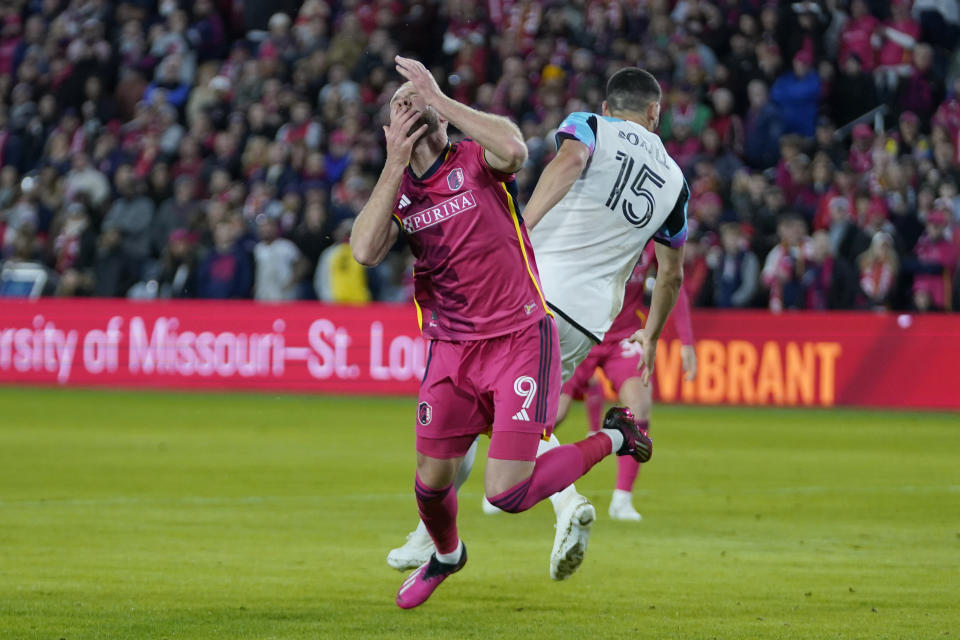 St. Louis City's Joao Klauss (9) collides with Minnesota United's Michael Boxall (15) during the second half of an MLS soccer match Saturday, April 1, 2023, in St. Louis. (AP Photo/Jeff Roberson)