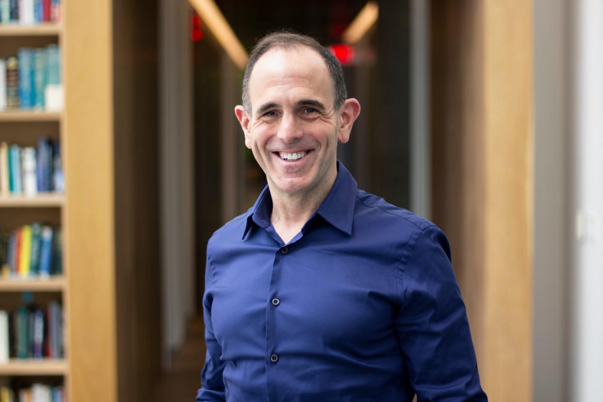 Keith Rabois standing in a library.
