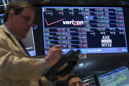 A trader works by the post where Verizon is traded on the floor of the New York Stock Exchange February 21, 2014. REUTERS/Brendan McDermid