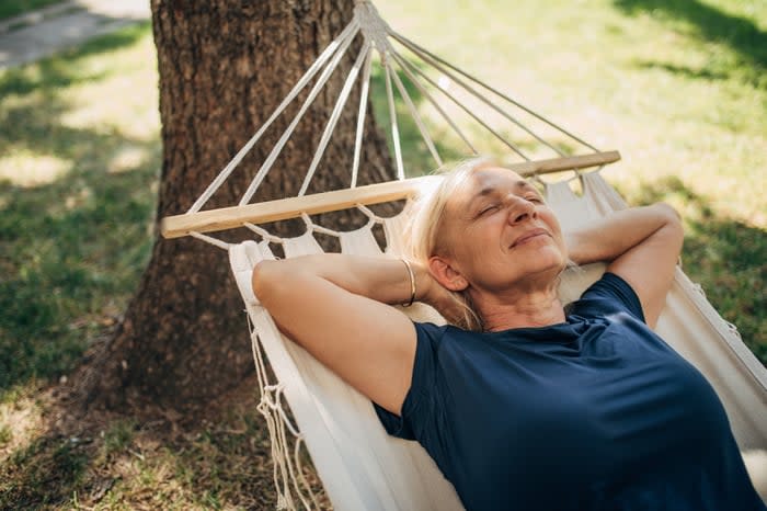 Relaxed person lying in hammock.