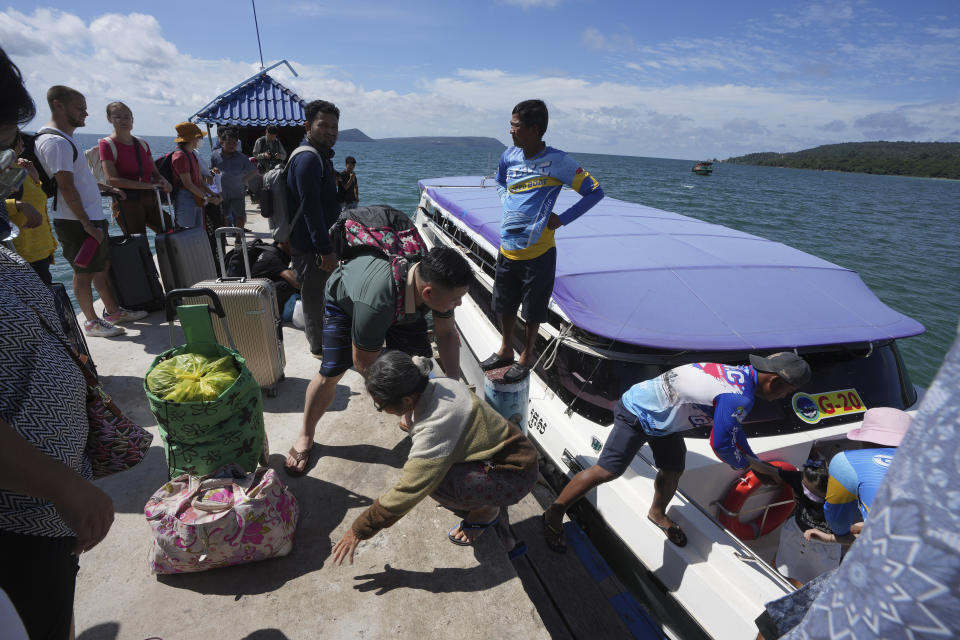 Tourists arrive at the Koh Rong island pier near where Chinese nationals were rescued from a sinking boat the night before in Preah Sihanouk Province, southwestern Cambodia on Saturday, Sept. 24, 2022. Two Cambodian crew members abandoned their boat with 41 Chinese nationals on board as it sank in the Gulf of Thailand, leaving at least one person dead and 19 missing, authorities said Friday. (AP Photo/Heng Sinith)