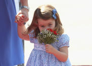 <p>Charlotte received a posy of her own when she arrived with her family on the royal tour of Germany. (Getty Images)</p> 