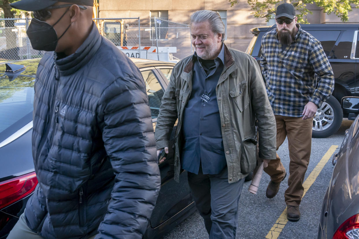 Steve Bannon, center, a longtime ally of former President Donald Trump, convicted of contempt of Congress, arrives at federal court for a sentencing hearing, Friday, Oct. 21, 2022, in Washington. (AP Photo/Nathan Howard)