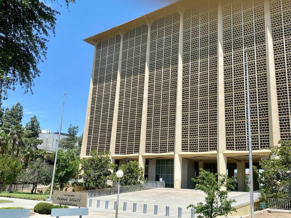 Empty flagpoles flank the sidewalk ramp to the Fresno County Courthouse from Courthouse Park in downtown Fresno on Tuesday, May 23, 2023. A new county ordinance, set to receive a final vote on June 6, would permit only the U.S. flag and California state flag to be flown on official flagpoles at county owned, leased or operated buildings, facilities or parks.