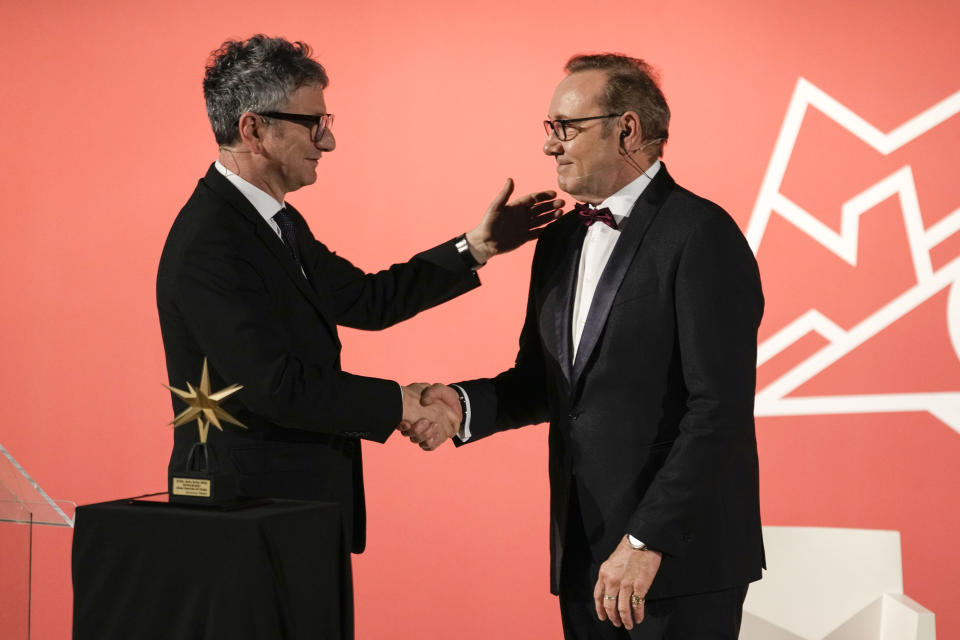 Actor Kevin Spacey, right, is welcomed by director Domenico De Gaetano, as he arrives at the National Museum of Cinema in Turin, Italy, Monday, Jan. 16, 2023. Kevin Spacey was in the northern Italian city of Turin on Monday to receive the lifetime achievement award, teach a master class and introduce a screening of the 1999 film "American Beauty." (AP Photo/Luca Bruno)