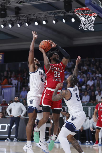 Texas Tech's Warren Washington shoots the ball guarded by Villanova's Justin Moore (5) and Villanova's Eric Dixon during an NCAA college basketball game in the Battle 4 Atlantis at Paradise Island, Bahamas, Wednesday, Nov. 22, 2023. (Tim Aylen/Bahamas Visual Services via AP)