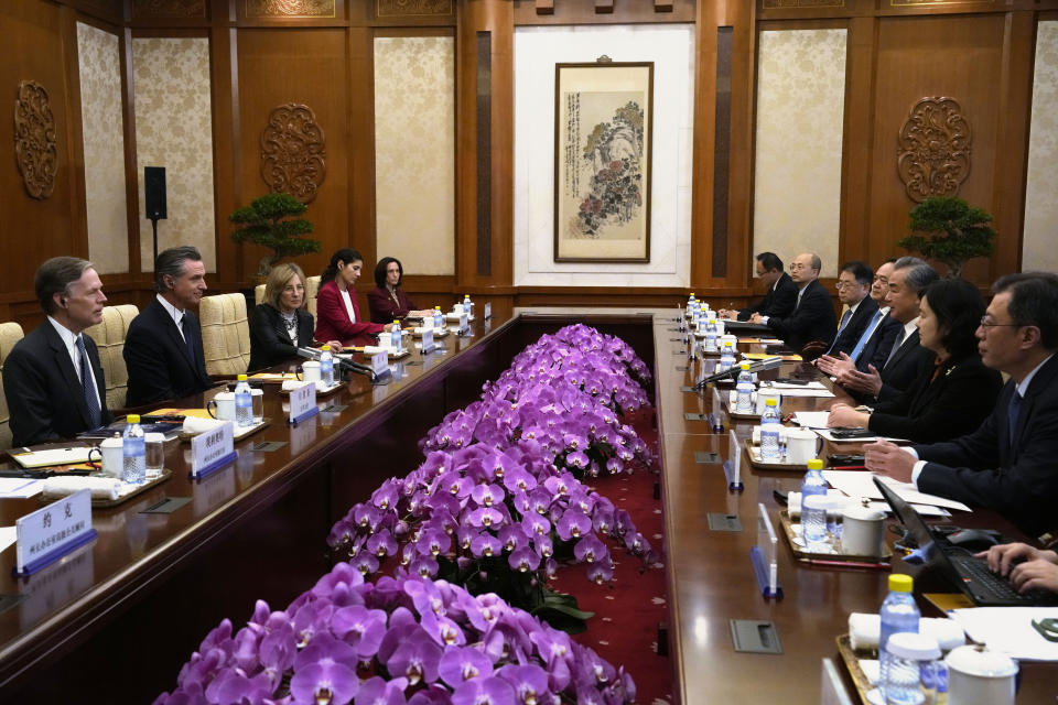 California Gov. Gavin Newsom, second from left, listens as Chinese Foreign Minister Wang Yi, third from right, speaks during a meeting at the Diaoyutai State Guest House in Beijing, Wednesday, Oct. 25, 2023. Newsom opened a weeklong trip to China with an assurance that his state will always be a partner on climate issues no matter how the U.S. presidential election turns out next year. (AP Photo/Ng Han Guan)