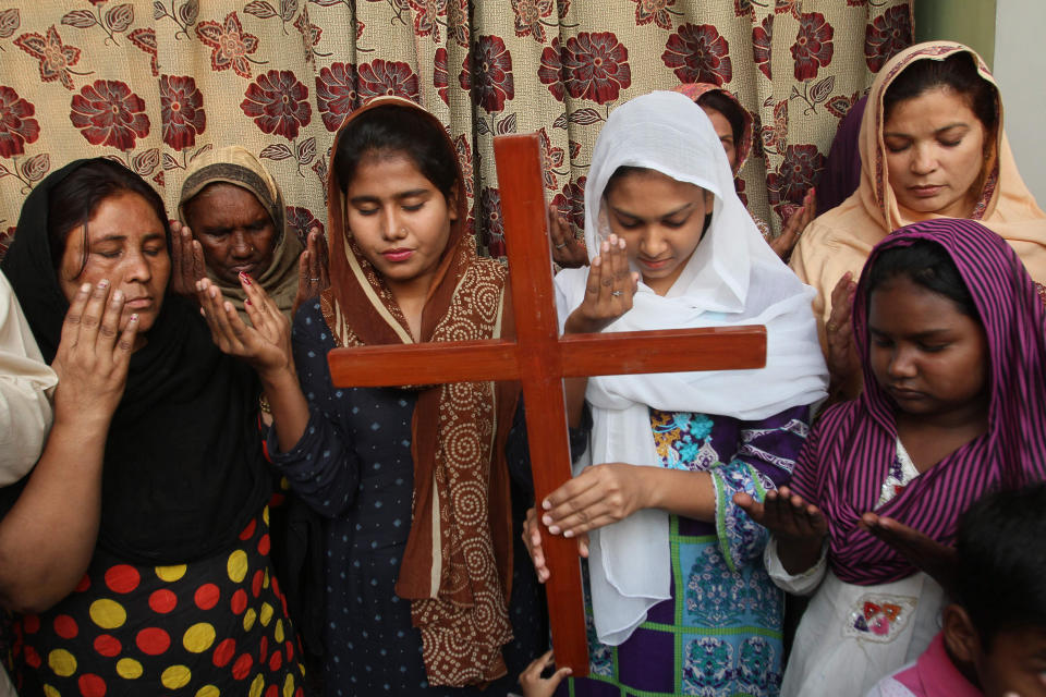 FILE - In this Oct. 31, 2018, file, photo Pakistan Christians pray for Aasia Bibi, a Catholic mother of five who has been on death row since 2010 accused of blasphemy in Multan, Pakistan. The uproar surrounding Aasia Bibi _ a Pakistani Christian woman who was acquitted of blasphemy charges and released from death row but remains in isolation for her protection _ has drawn attention to the plight of the country's Christians.The minority, among Pakistan's poorest, has faced an increasingly intolerant atmosphere in this Muslim-majority nation where radical religious and sectarian groups have become more prominent in recent years. (AP Photo/Irum Asim, File)