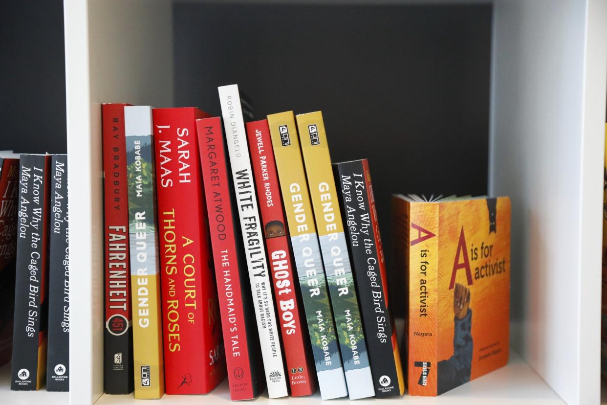 Books are displayed at the Banned Book Library at American Stage in St. Petersburg, Fla., Feb. 18, 2023. In Florida, some schools have covered or removed books under a new law that requires an evaluation of reading materials and for districts to publish a searchable list of books where individuals can then challenge specific titles. (Jefferee Woo/Tampa Bay Times via AP)