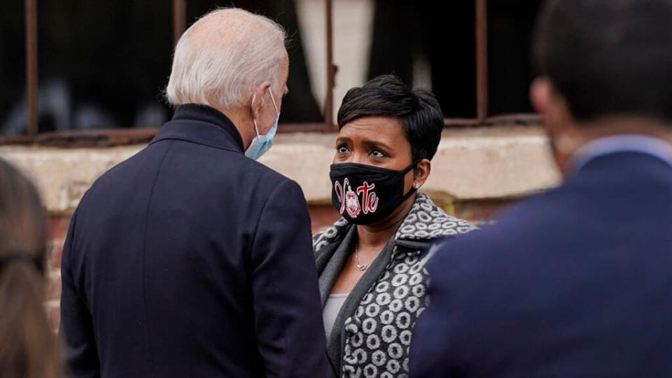 U.S. President-elect Joe Biden talks with Atlanta Mayor Keisha Lance Bottoms after a drive-in rally for U.S. Senate candidates Jon Ossoff and Rev. Raphael Warnock at Pullman Yard on December 15, 2020 in Atlanta, Georgia. (Photo by Drew Angerer/Getty Images)