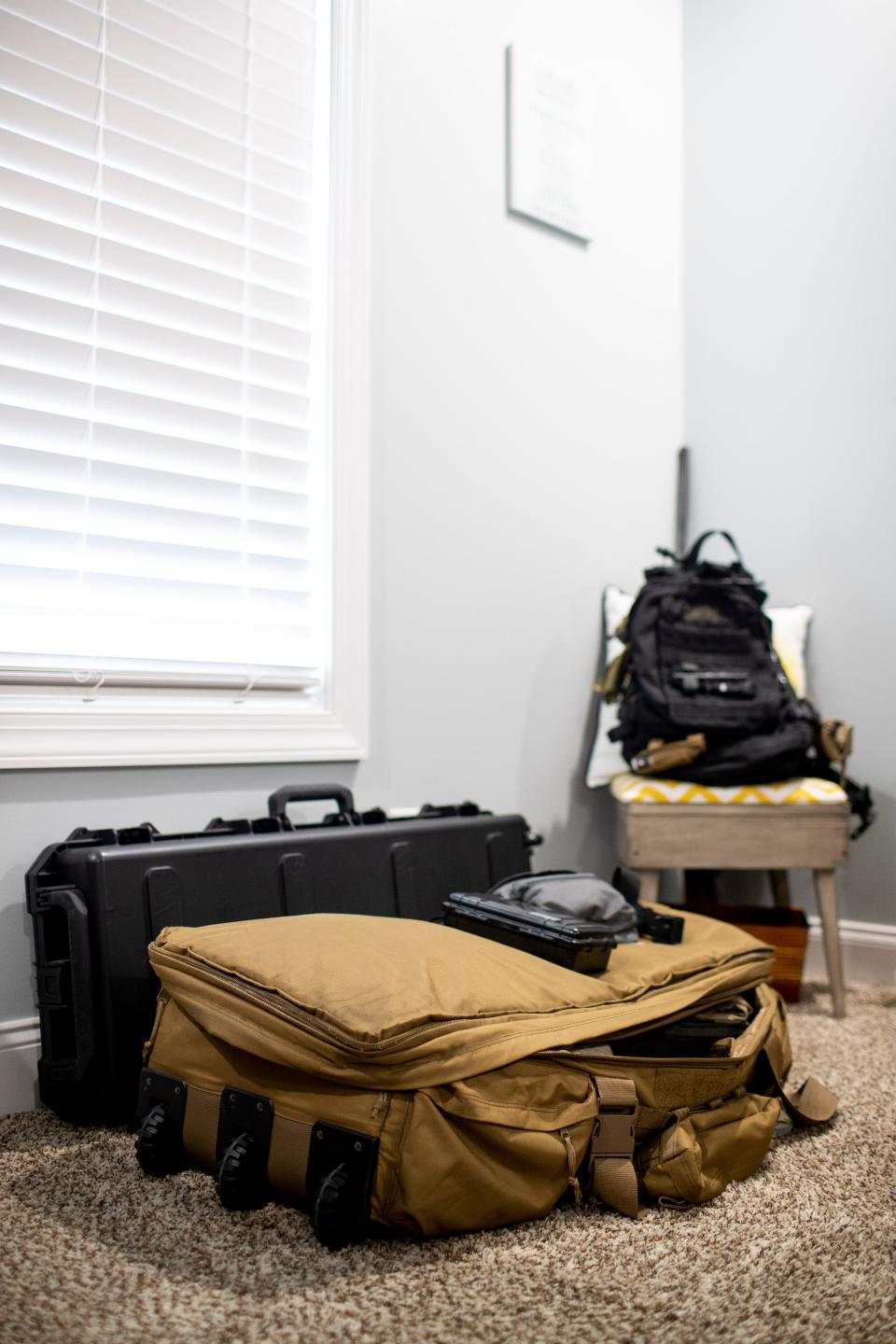 Frank Tate's go-bag sits ready for travel at the Tate household in Clarksville, Tenn., on Saturday, March 19, 2022, complete with hot hands for the Ukrainian weather and tourniquets, a luxury in high demand in that area.