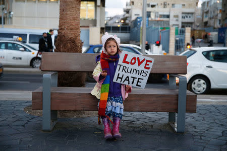 A young girl holds a placard during a protest against the meeting between U.S. President Donald Trump and Israeli Prime Minister Benjamin Netanyahu in Washington, outside the U.S. embassy in Tel Aviv, Israel February 15, 2017. REUTERS/Baz Ratner