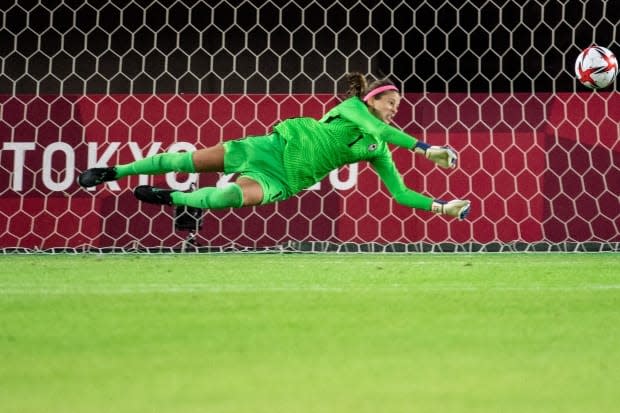 Canada's goalkeeper Stephanie Labbé saves a penalty by Brazil's midfielder Andressa during the Tokyo 2020 Olympic Games women's quarter-final football match between Canada and Brazil at Miyagi Stadium in Miyagi, Japan, on Friday. Canada won the watch 4-3 on penalties. (AFP via Getty Images - image credit)
