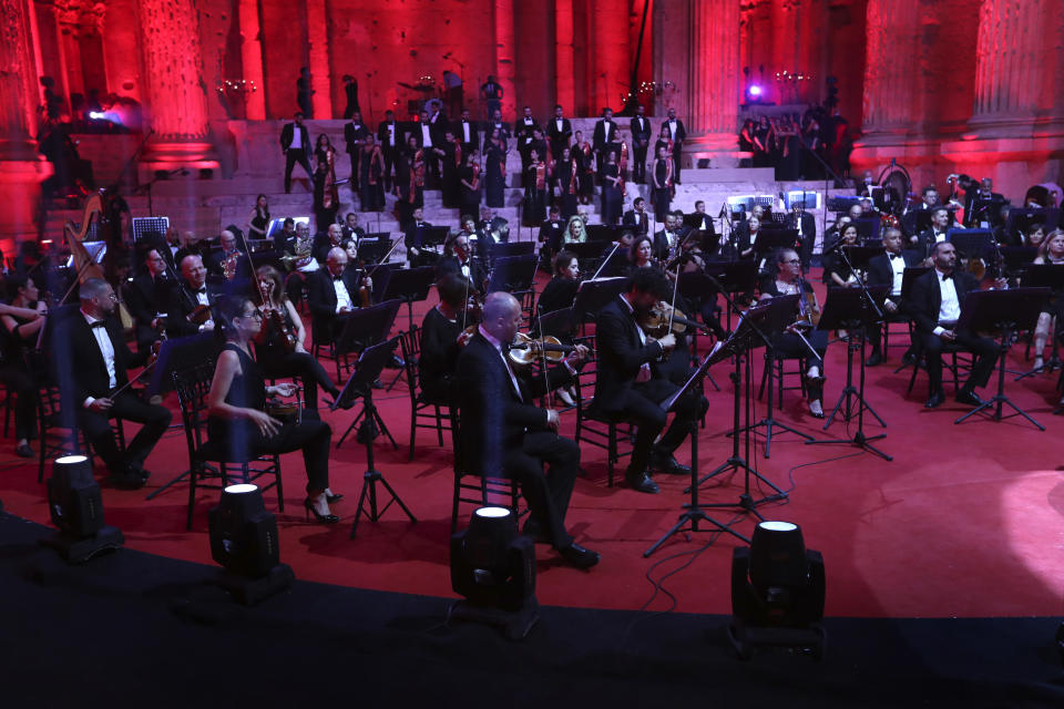 Musicians from the Lebanese Philharmonic Orchestra perform during a concert in the ancient northeastern city of Baalbek, Lebanon, Sunday, July 5, 2020. Dubbed "an act of cultural resilience," the concert aims to send a message of unity and hope to the world amid the coronavirus pandemic and an unprecedented economic and financial crisis in Lebanon. For the first time since the Baalbek International Festival was launched in 1956, this year's concert is being held without an audience, in line with strict COVID-19 guidelines. Instead, it is being broadcast live on local and regional TV stations and live-streamed on social media platforms. (AP Photo/Bilal Hussein)