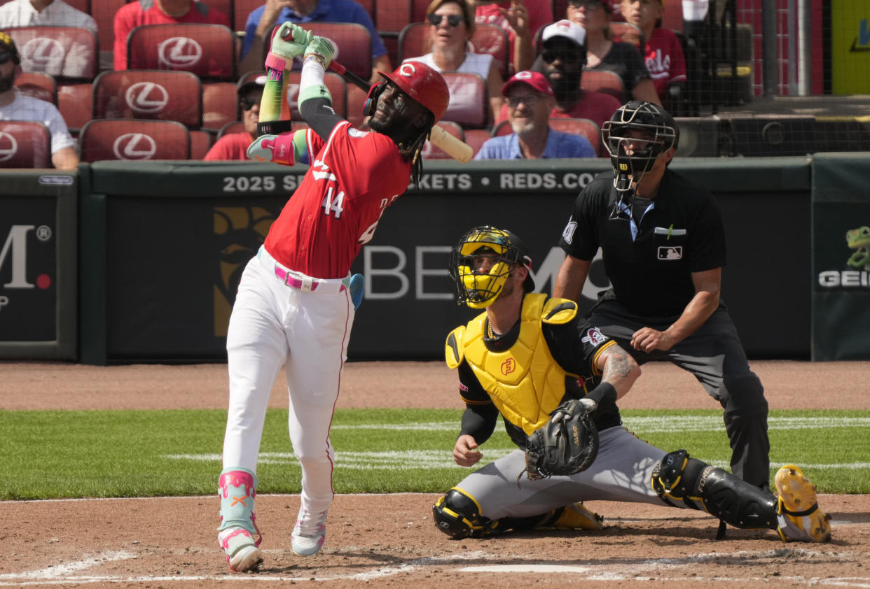 Cincinnati Reds' Elly De La Cruz watches his three-run homer with Pittsburgh Pirates catcher Yasmani Grandal (6) and home plate umpire Charlie Ramos during the fourth inning of a baseball game, Saturday, Sept. 21, 2024, in Cincinnati. (AP Photo/Carolyn Kaster)