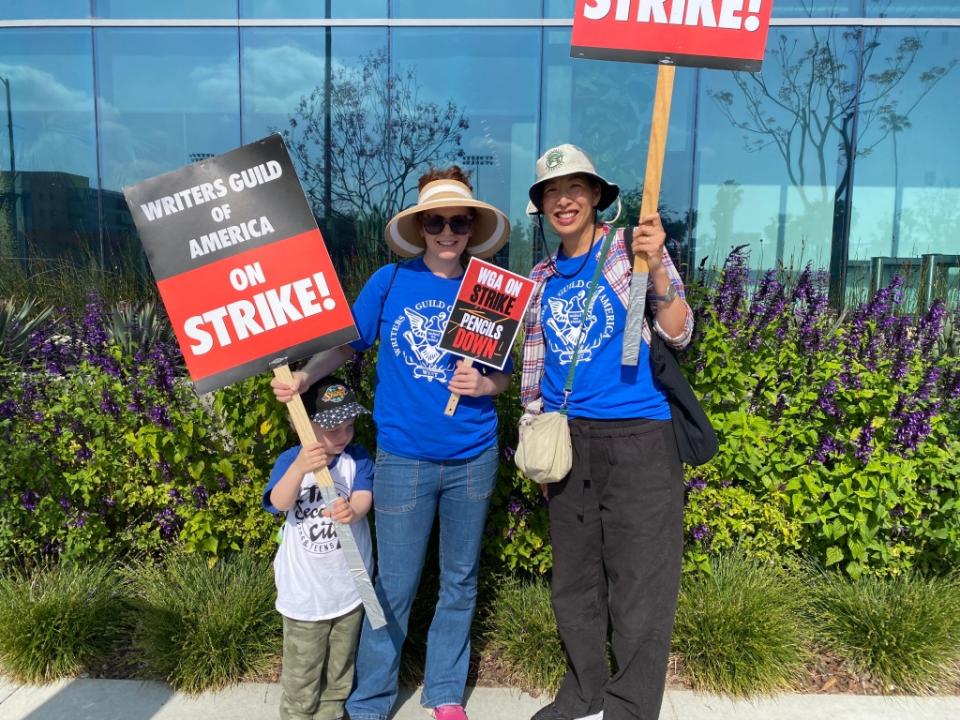 Beau Eichhorn with his mother Laura Eichhorn and friend Janet Lin on the WGA picket line outside Netflix in Hollywood