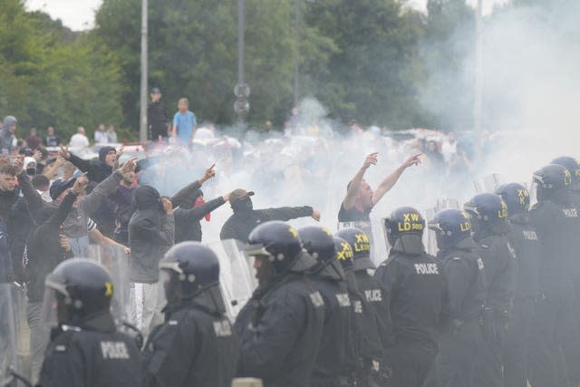 Protesters face a line of riot police