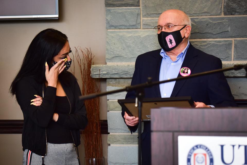 From left, Tiana Guzman wipes away a tear as she is presented with the first award from the Bianca Michelle Devins Memorial Scholarship Fund by Devins' grandfather Frank Williams on Wednesday, Oct. 7, 2020 at Utica College. Members of the Devins and Williams families created the fund at the Community Foundation of Herkimer and Oneida Counties last year to support students pursuing a degree in psychology to continue Bianca’s dream of helping adolescents with mental illnesses.