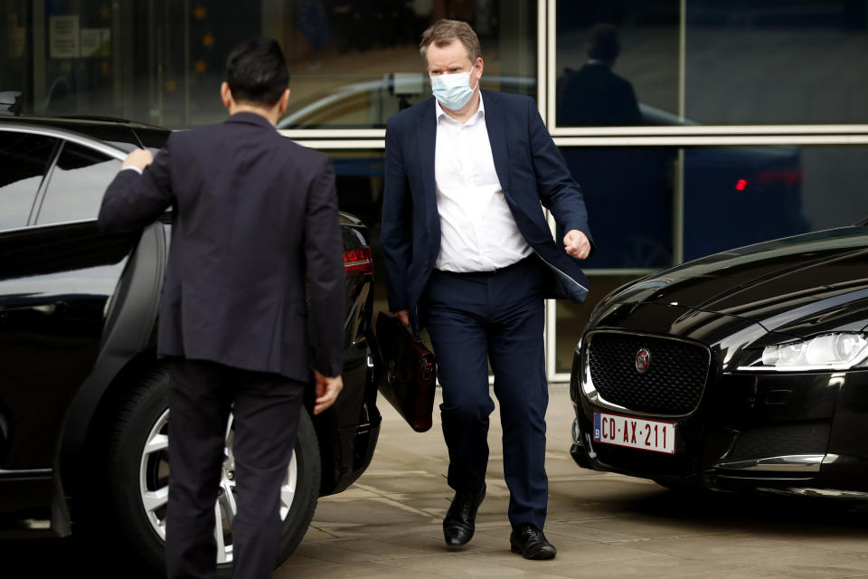 Britain's chief negotiator David Frost, center, leaves EU headquarters after a meeting with EU chief negotiator Michel Barnier in Brussels, Sunday, Dec. 20, 2020. The EU and the United Kingdom were still working Sunday on a "last attempt" to clinch a post-Brexit trade deal, with EU fishing rights in British waters the most notable remaining obstacle to avoid a chaotic and costly changeover on New Year. (AP Photo/Francisco Seco)