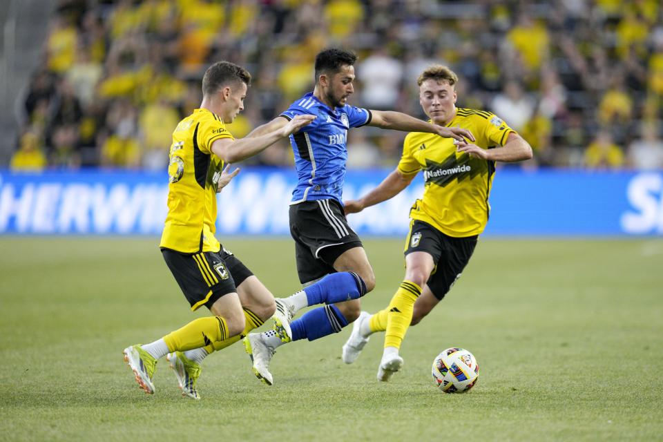 CF Montréal forward Matías Cóccaro, center, works against Columbus Crew's Sean Zawadzki, left, and Aidan Morris during the first half of an MLS soccer match Saturday, April 27, 2024, in Columbus, Ohio. (AP Photo/Jeff Dean)