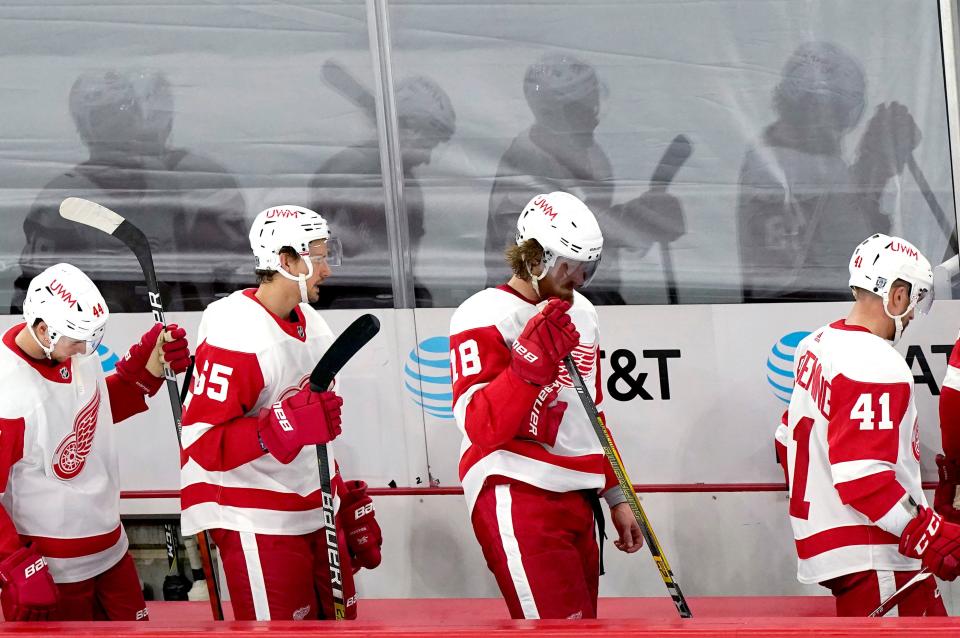 Detroit Red Wings players leave the ice following a loss to the Chicago Blackhawks in an NHL hockey game in Chicago, Sunday, Jan. 24, 2021.