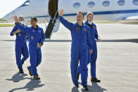 European Space Agency astronaut Matthias Maurer, of Germany, second from right, waves as he walks with fellow crew members, from left, NASA astronauts Tom Marshburn, Raja Chari, and Kayla Barron after arriving at the Kennedy Space Center in Cape Canaveral, Fla., Tuesday, Oct. 26, 2021. The mission, with a crew of four astronauts, will launch aboard a Crew Dragon spacecraft on SpaceX's Falcon 9 rocket from Kennedy's Launch Complex 39A early Sunday morning to the International Space Station. (AP Photo/John Raoux)