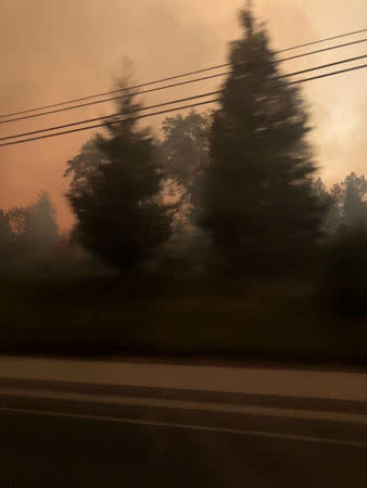 Smoke is seen during evacuation from Paradise to Chico, in Butte County, California, U.S in this November 8, 2018 picture obtained from social media. @dlmadethecut/via REUTERS