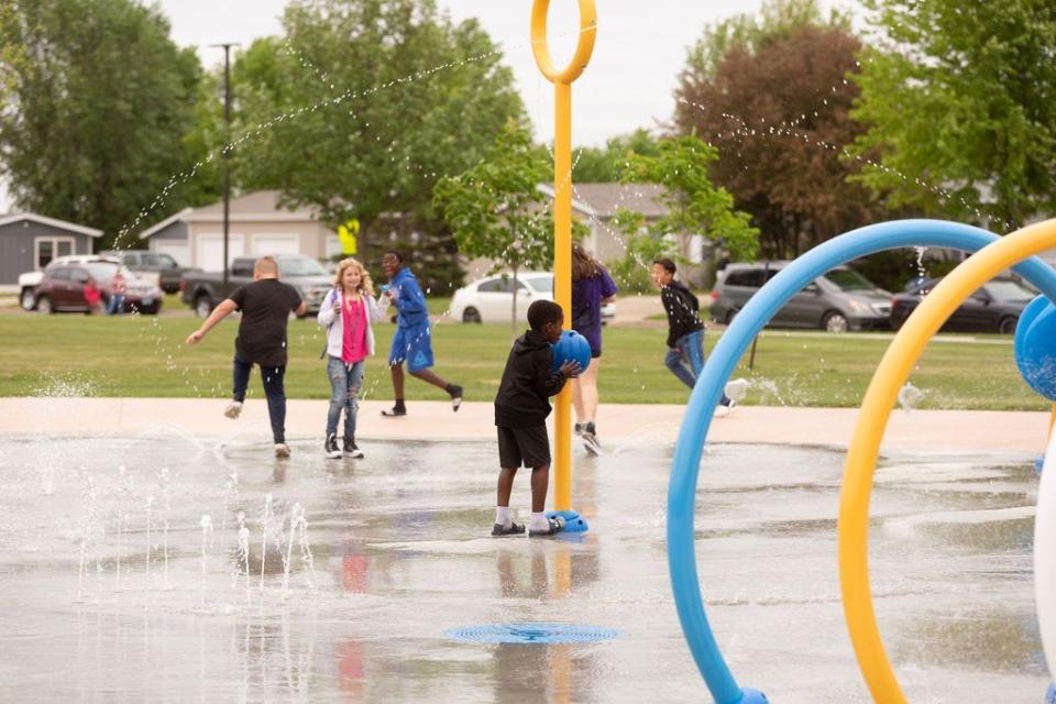 Children play at the newly-opened splash pad in Hayward Park