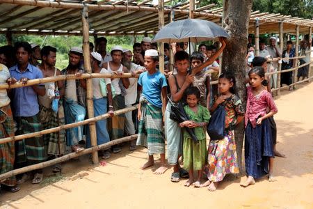 Rohingya refugees stand in a queue to collect relief supplies at a refugee camp in Cox's Bazar, Bangladesh, July 1, 2018. REUTERS/Mohammad Ponir Hossain