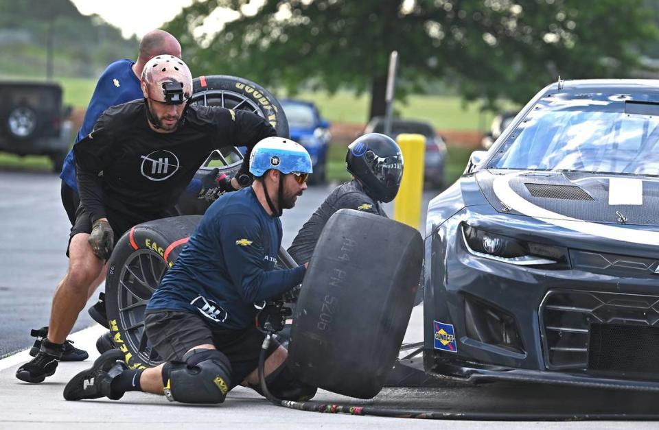 NASCAR driver Ross Chastain’s Trackhouse Racing pit crew members (L-R) Matt Simmons, Ken Pozega, Shane Wilson and Michael Roberts change the tires during pit practice on Tuesday, June 11, 2024.