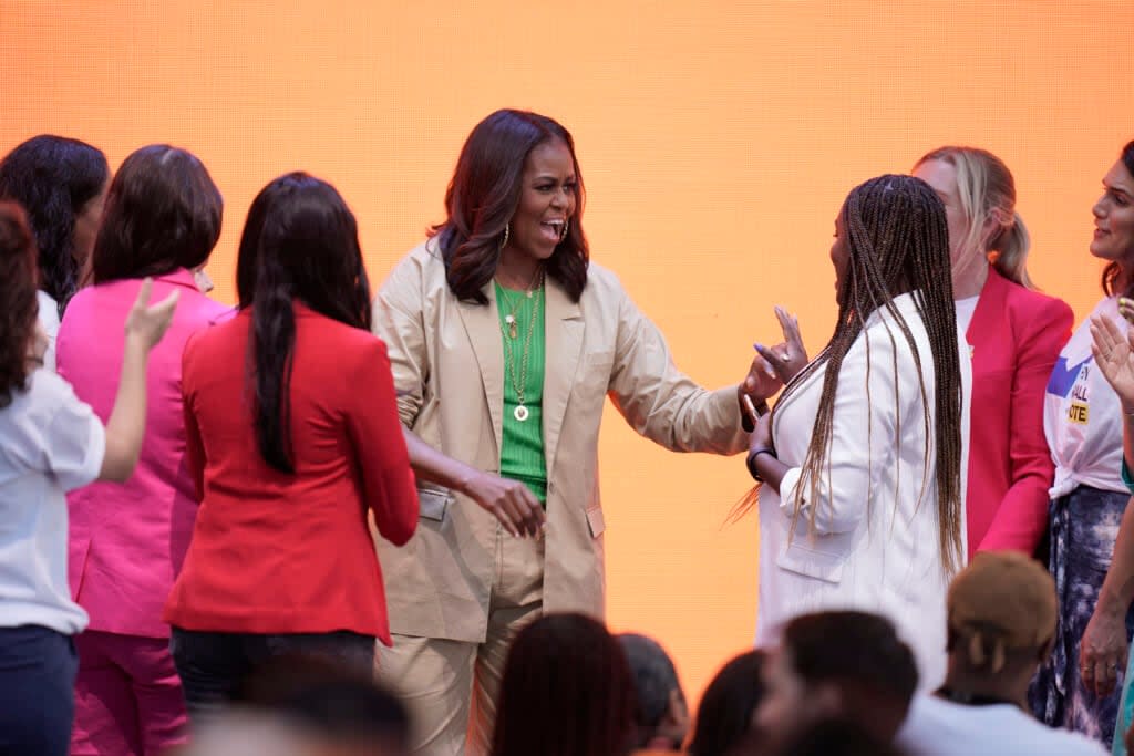 Former first lady Michelle Obama, center, interacts with When We All Vote staff members after speaking at the Culture of Democracy Summit in Los Angeles, Monday, June 13, 2022. (AP Photo/Jae C. Hong)